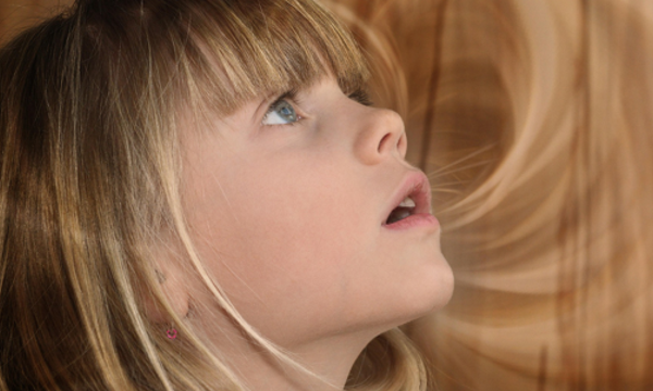 Ein Mädchen schaut staunend nach oben.